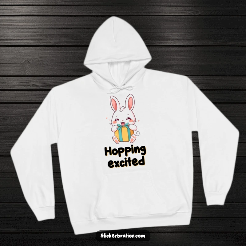 Funny hoodie showcasing a chubby bunny character eagerly unwrapping a brightly colored gift, embodying happy anticipation and comfort.
