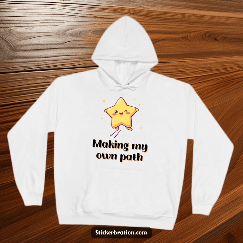 Funny hoodie featuring a star character leaping with joy, leaving behind trails of glitter, perfect for cozy happiness.