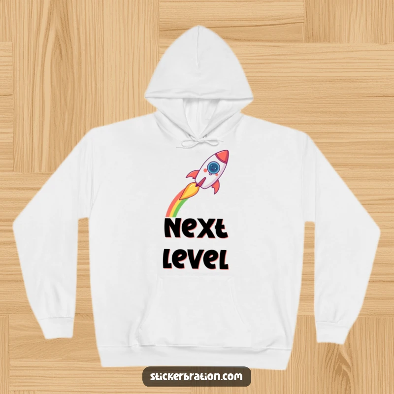 Funny rocket hoodie with a cheerful rocket creating a rainbow trail, offering cozy comfort and whimsical cosmic humor.